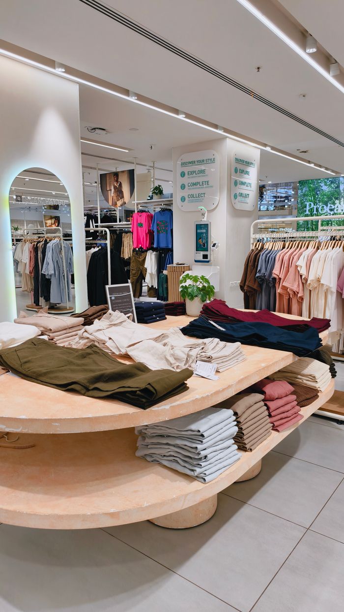 Elegant shopping space featuring organized displays of trendy apparel in a modern retail store.